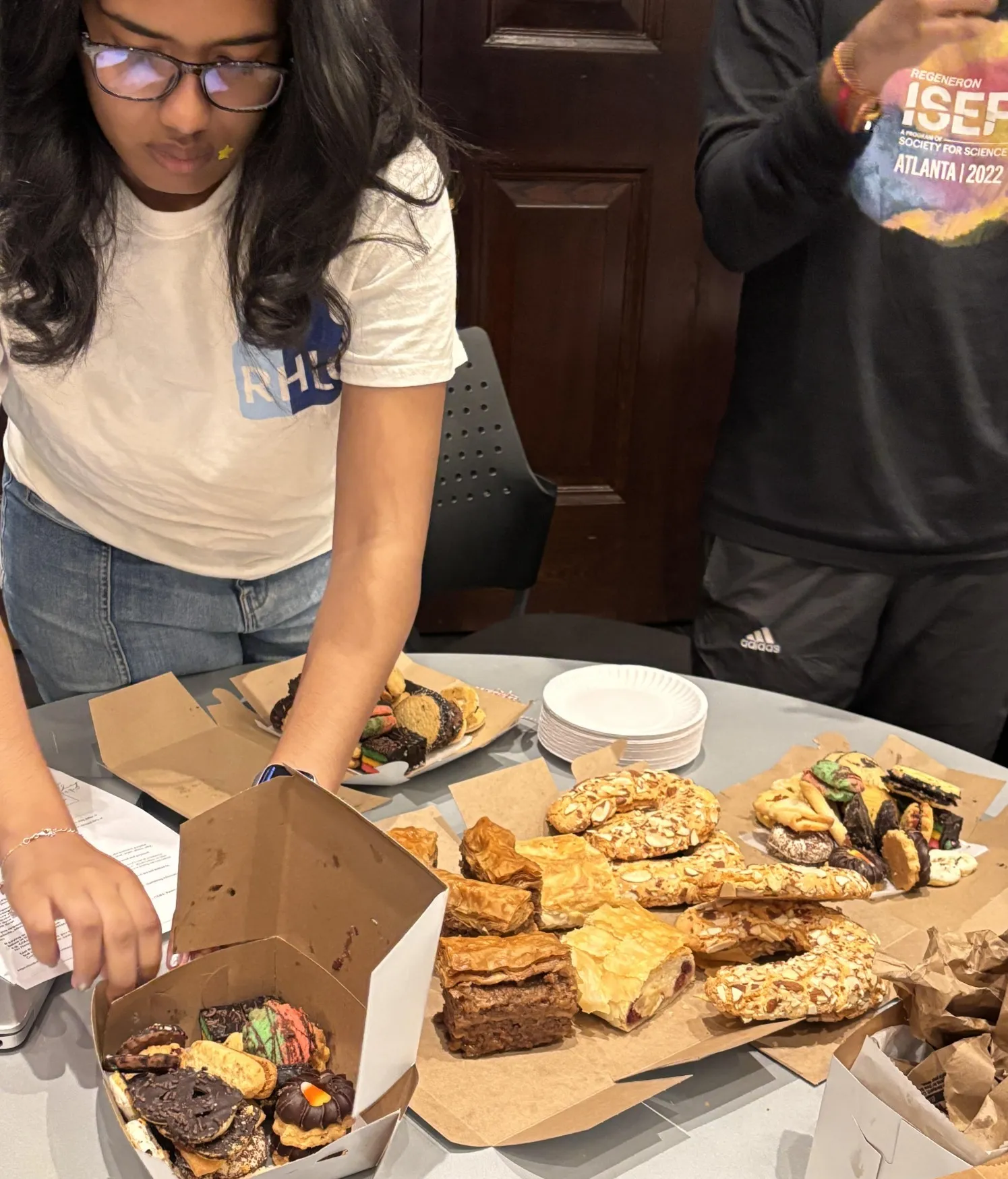 Programming Director (Maya Aviles, pictured) setting out pastries from Hungarian Pastry Shop